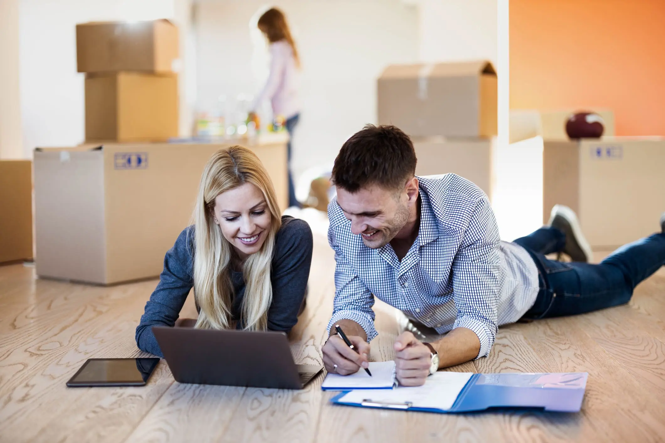 Couple planning in new home with boxes.