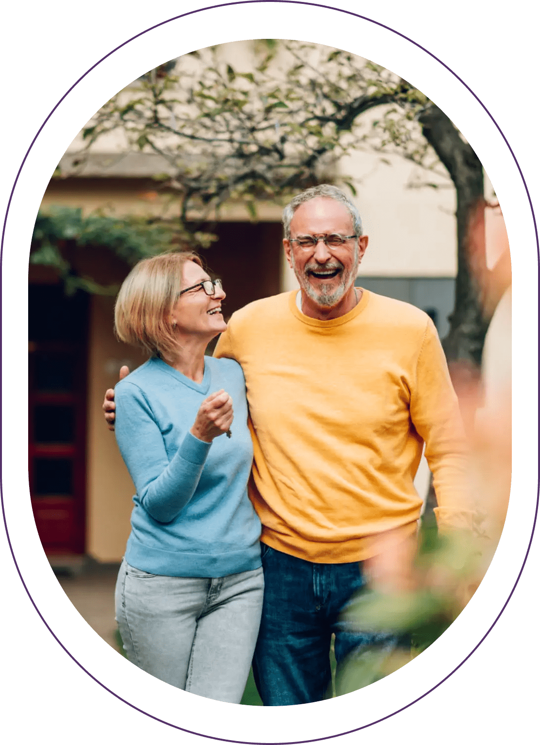 Smiling couple walking outdoors in bright clothing.