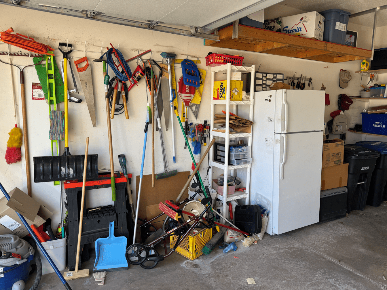 Cluttered garage with tools and appliances.