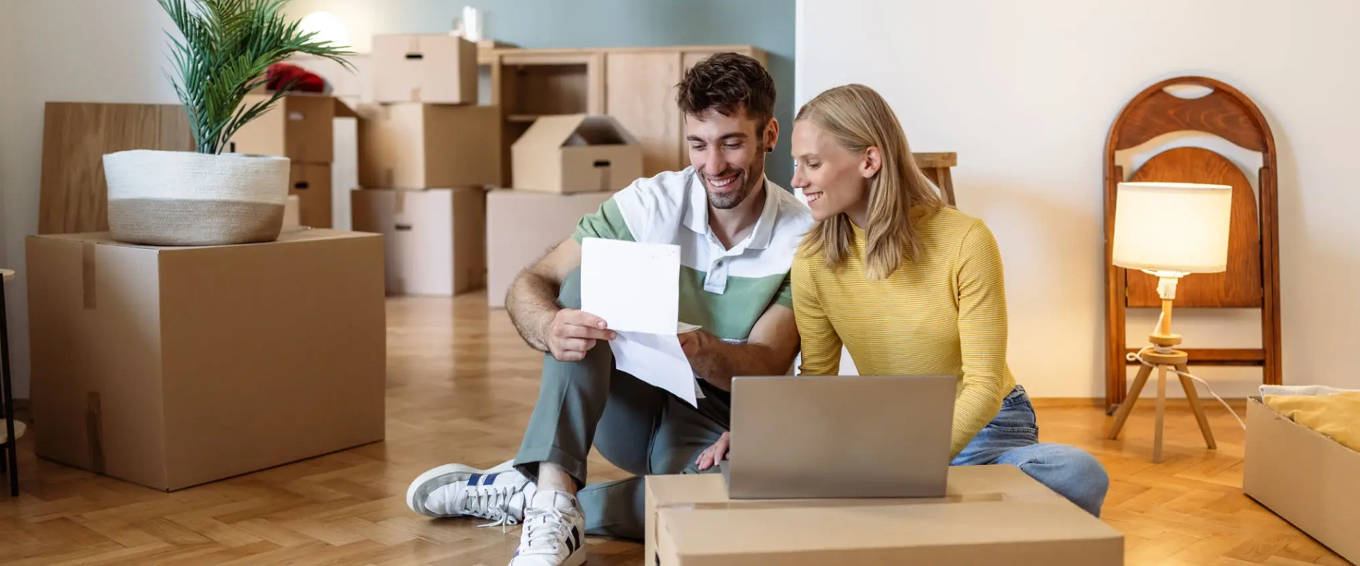 Couple unpacking boxes in new home.