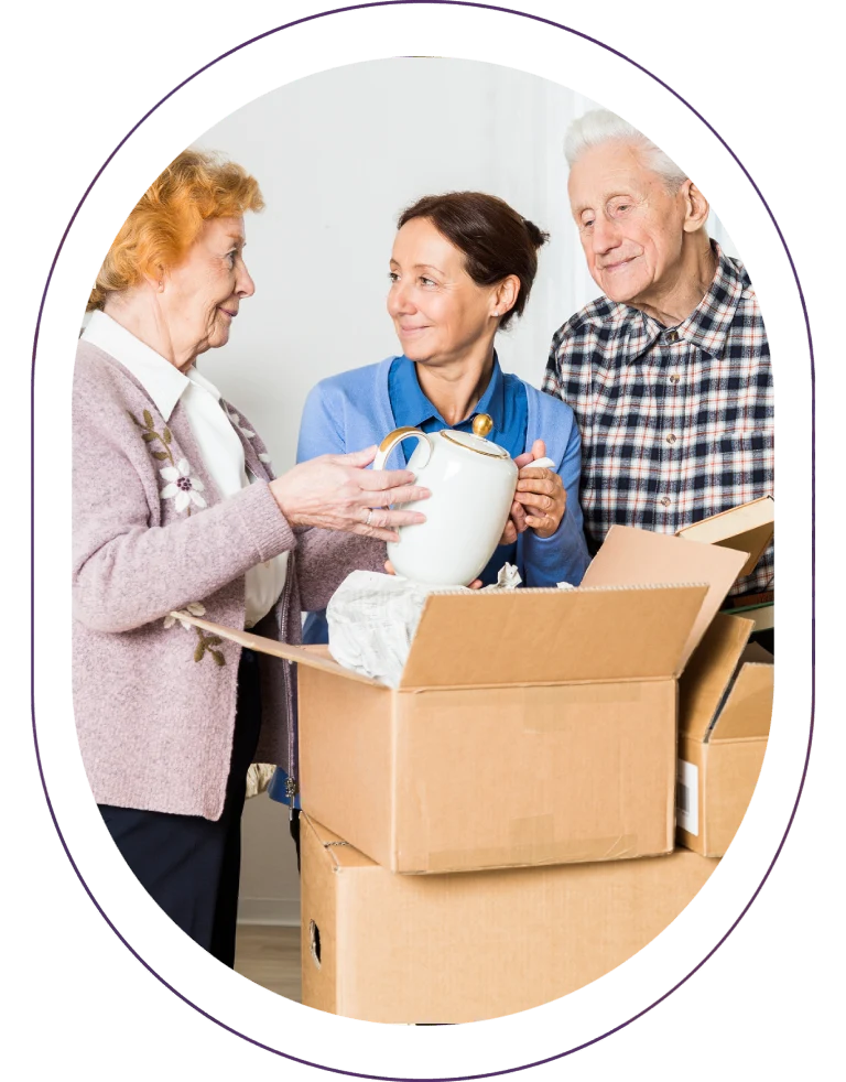 Seniors unpacking boxes with a caregiver.