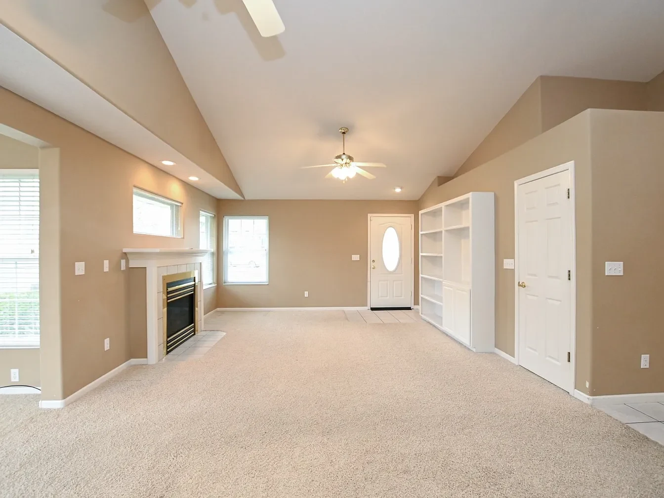 Spacious living room with beige walls.