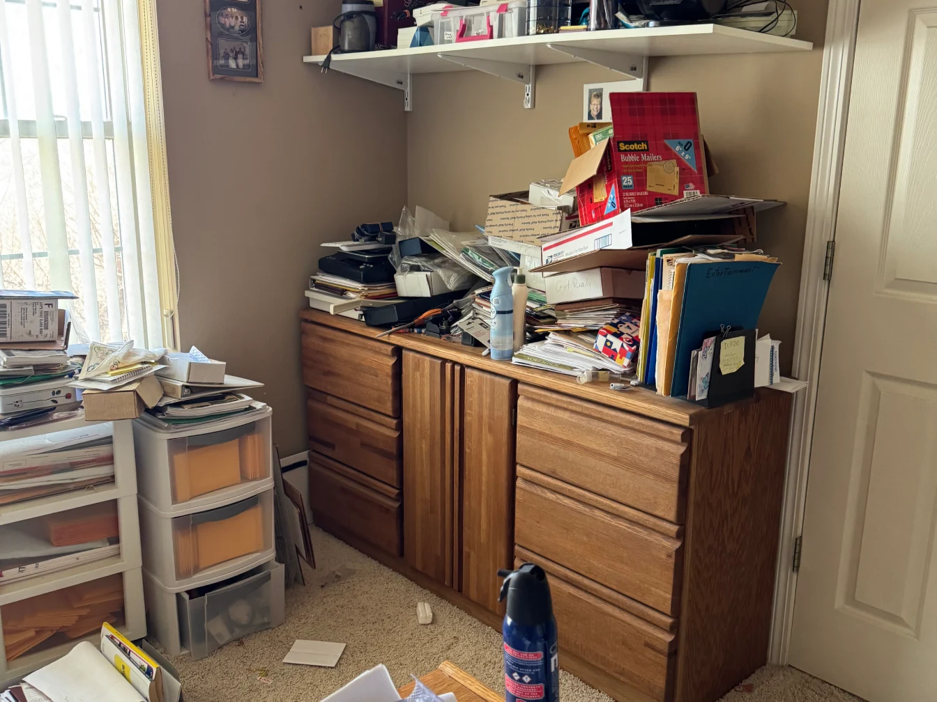 Cluttered office with shelves and cabinets.